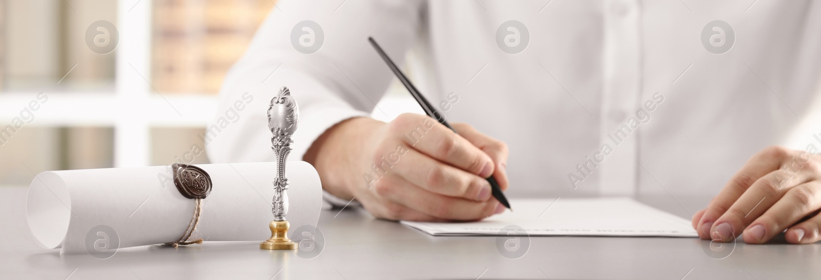 Image of Male notary working with documents at table in office, closeup. Banner design