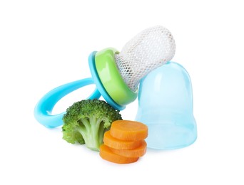 Photo of Empty nibbler with boiled broccoli and cut carrot on white background. Baby feeder