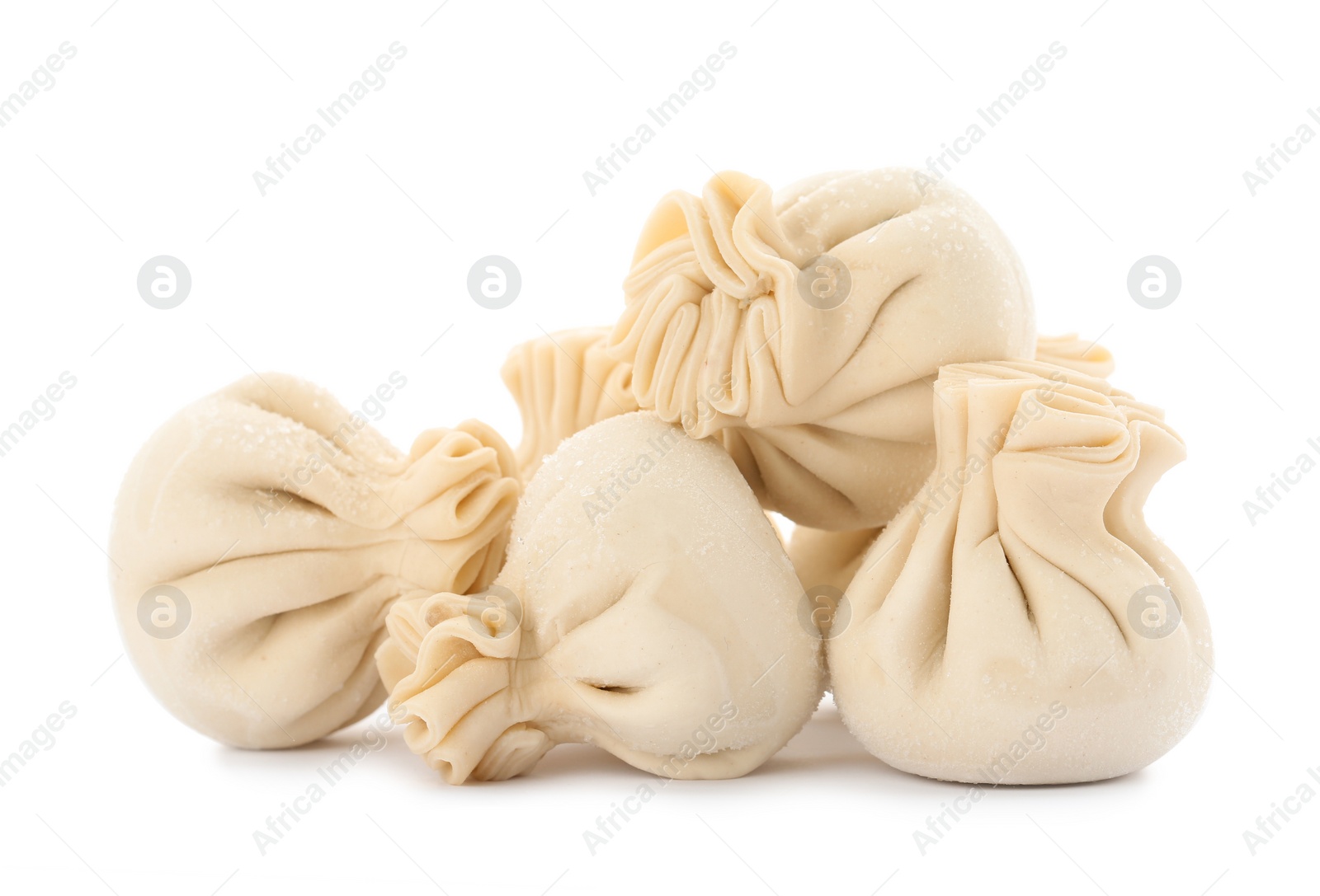 Photo of Heap of raw dumplings with tasty filling on white background