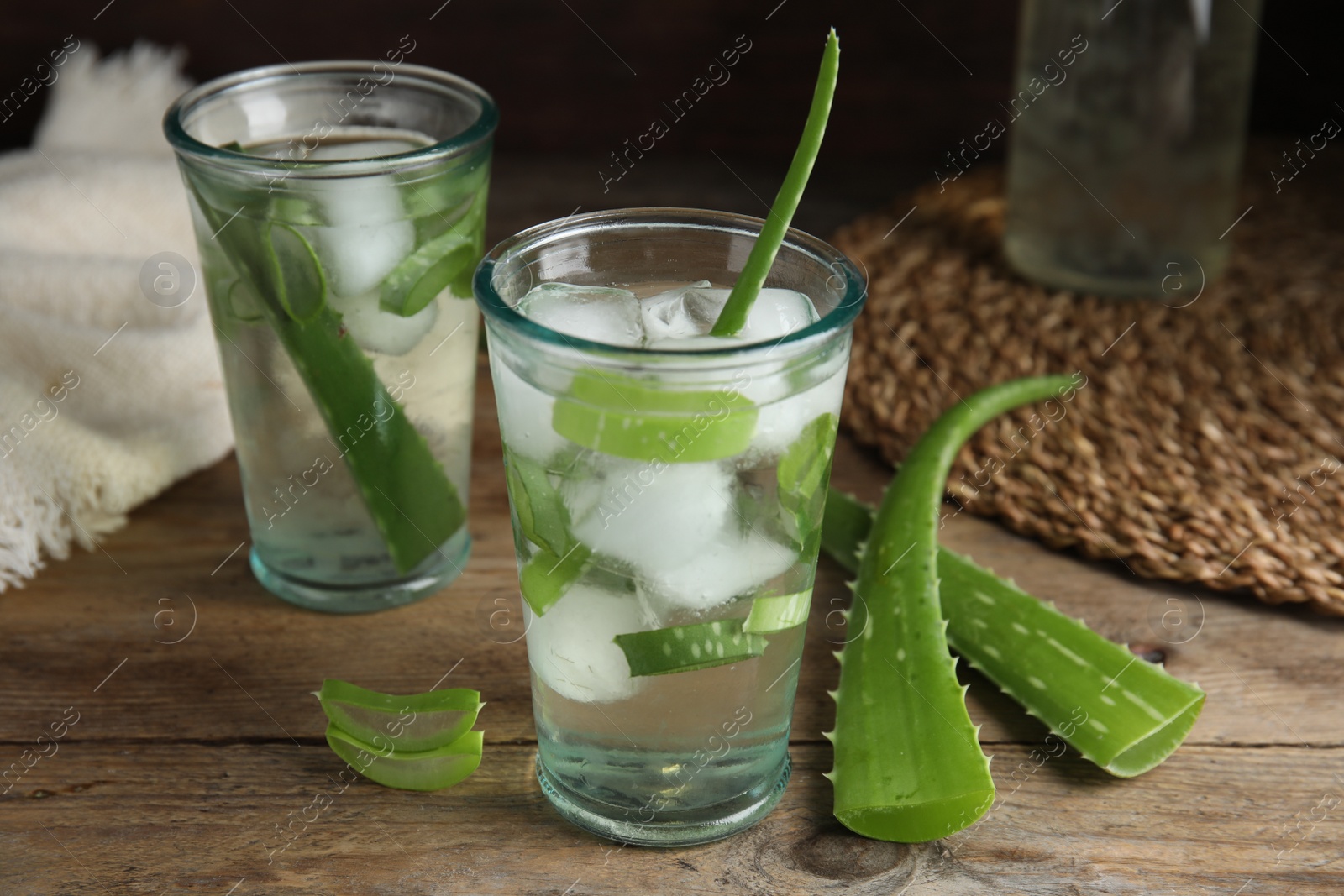 Photo of Fresh aloe drink with ice cubes on wooden table