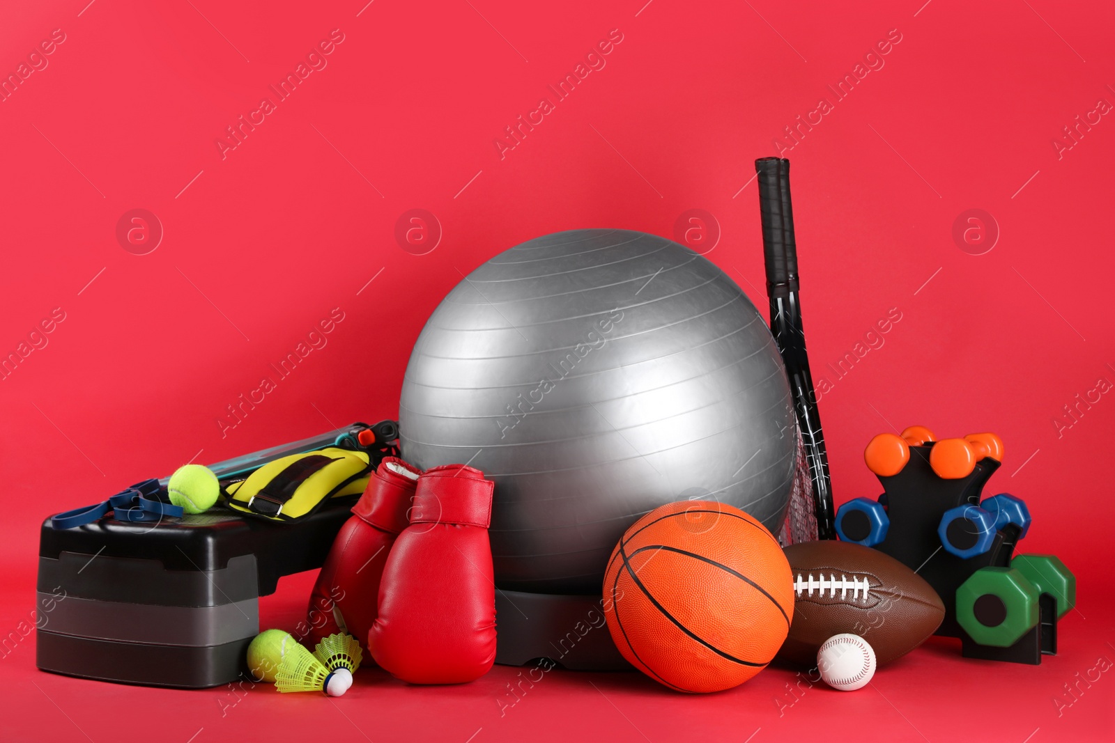 Photo of Set of different sports equipment on red background