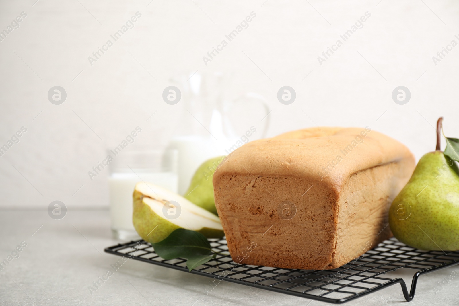 Photo of Tasty bread and pears on light grey table. Homemade cake