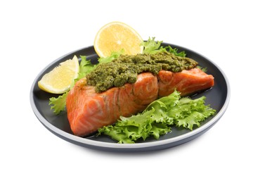 Photo of Delicious cooked salmon with pesto sauce, lettuce and lemon on white background