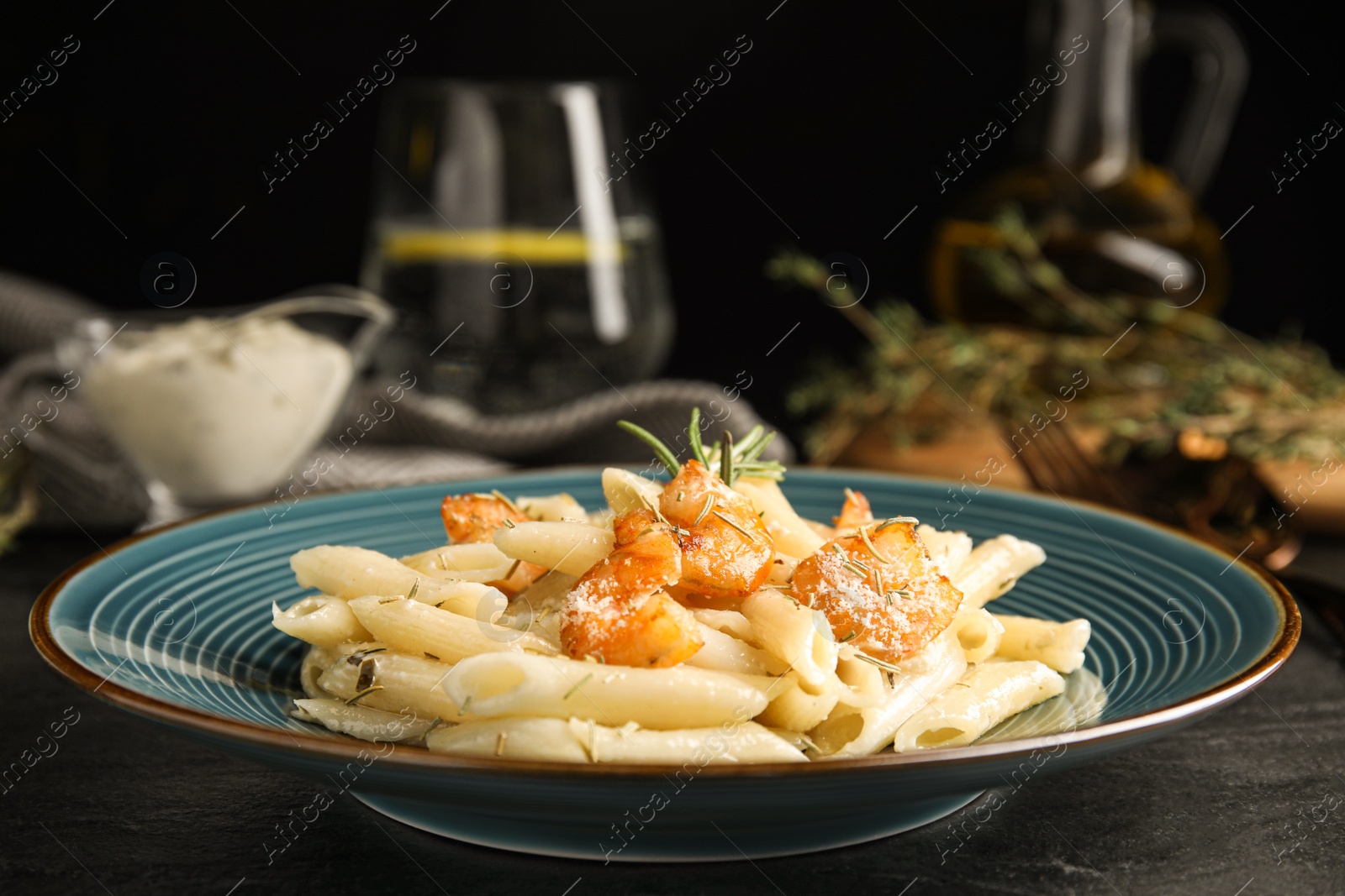 Photo of Delicious pasta with shrimps on black table