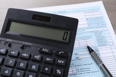 Photo of Tax accounting. Calculator, document and pen on table, closeup