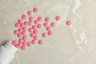 Bottle with pills on light background