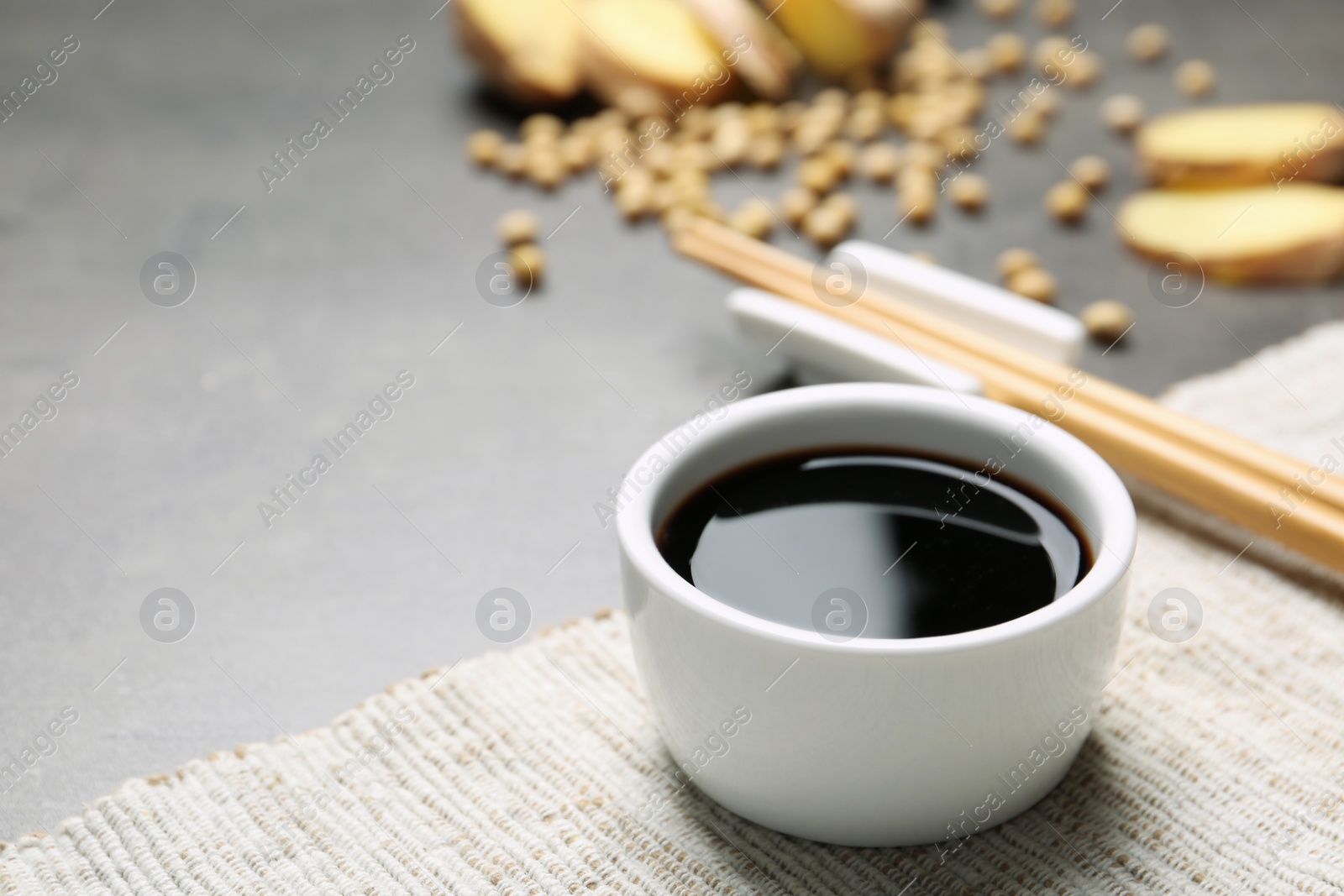 Photo of Bowl of soy sauce on table. Space for text