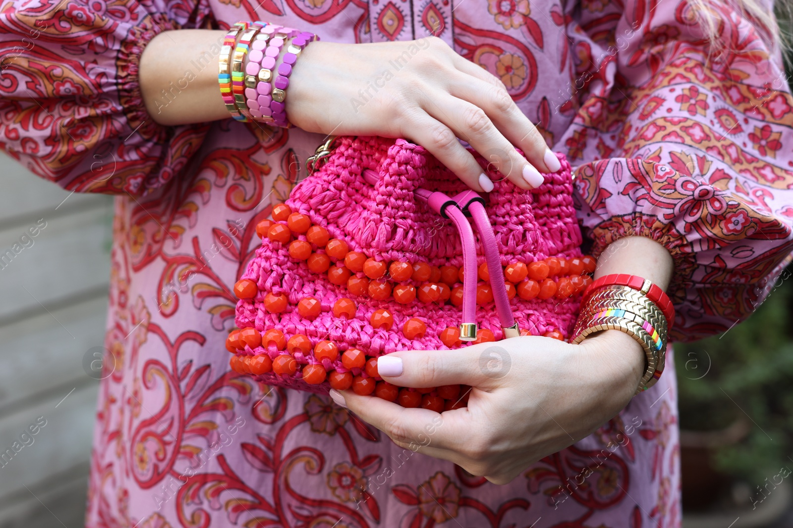 Photo of Woman with stylish purse wearing bracelets outdoors, closeup