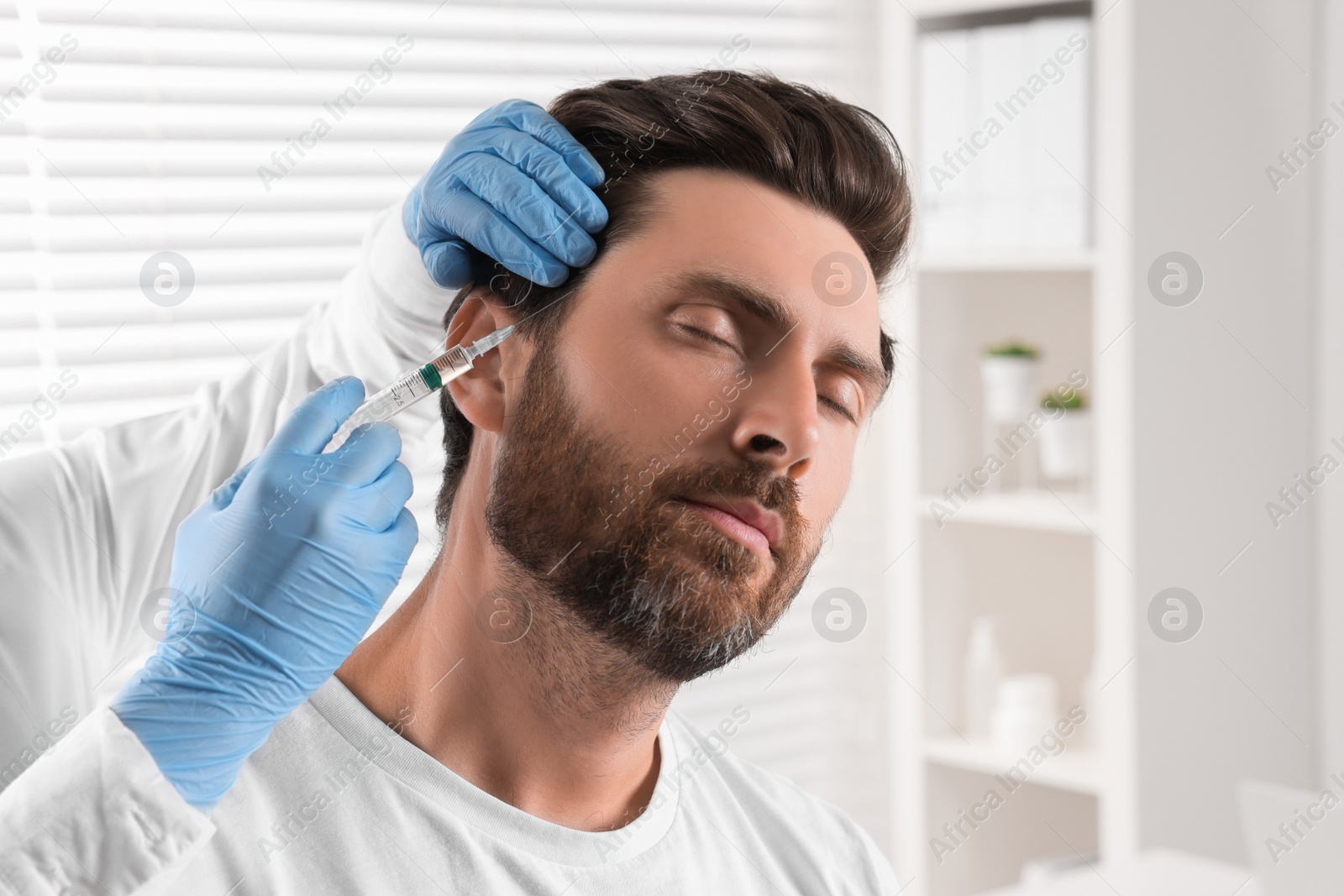 Photo of Trichologist giving injection to patient in clinic, closeup