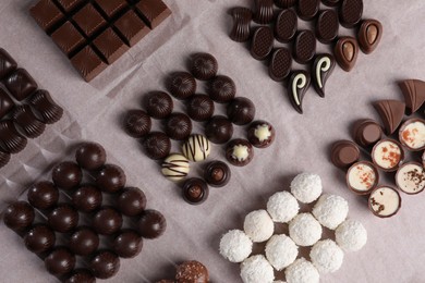 Many delicious chocolate candies on table, flat lay. Production line