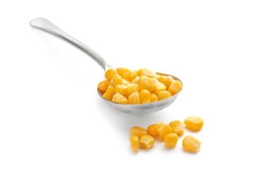 Photo of Spoon with corn kernels on white background