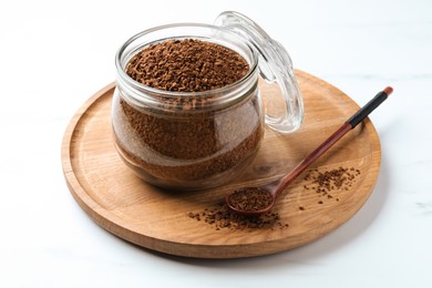 Photo of Jar of instant coffee and spoon on white table