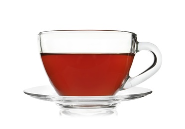 Photo of Glass cup of tea and saucer on white background