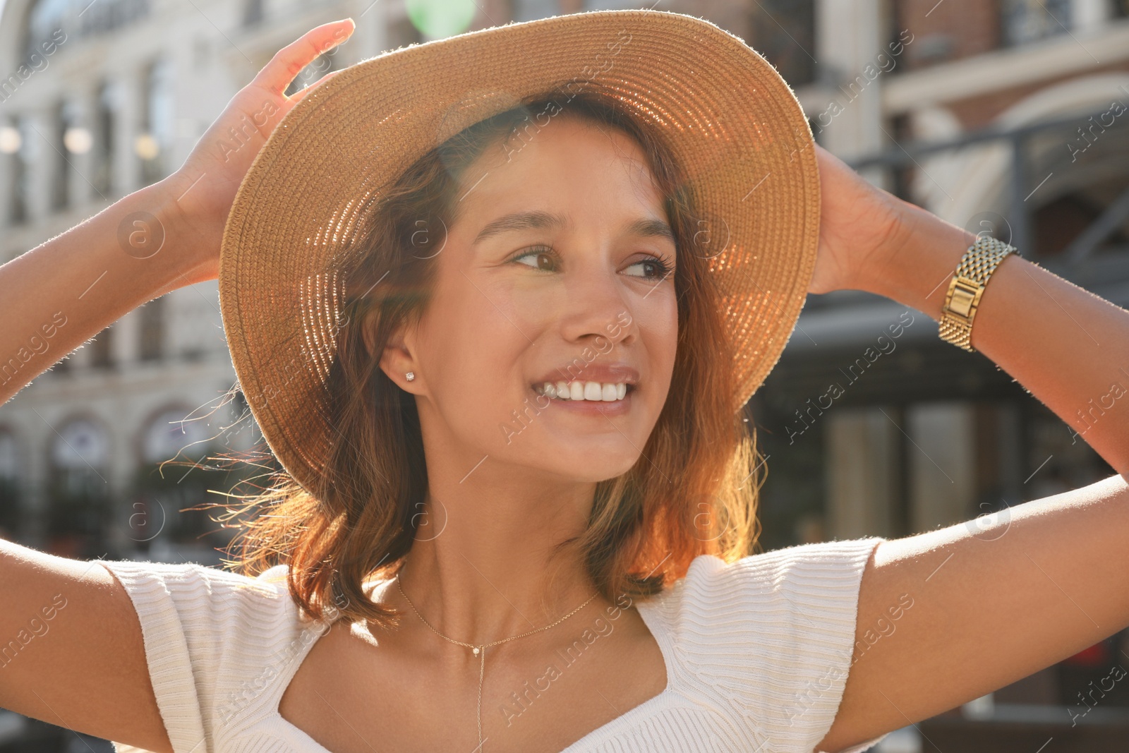 Photo of Portrait of happy young woman on city street