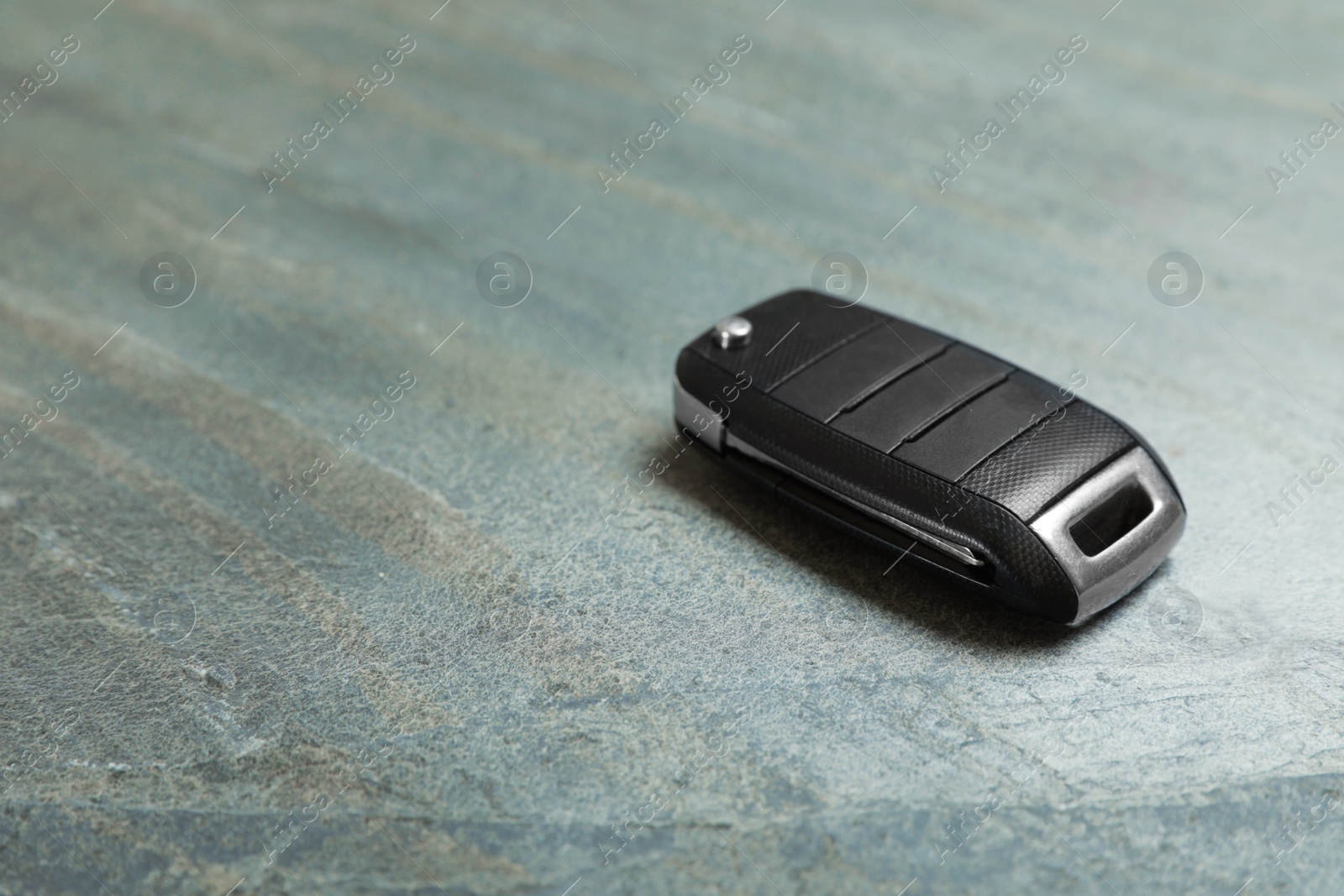 Photo of Car flip key on grey background. Space for text