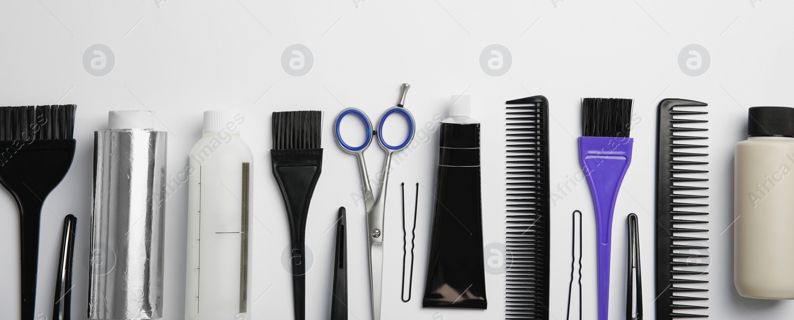 Image of Set of different professional tools for hair dyeing on white background, flat lay. Banner design