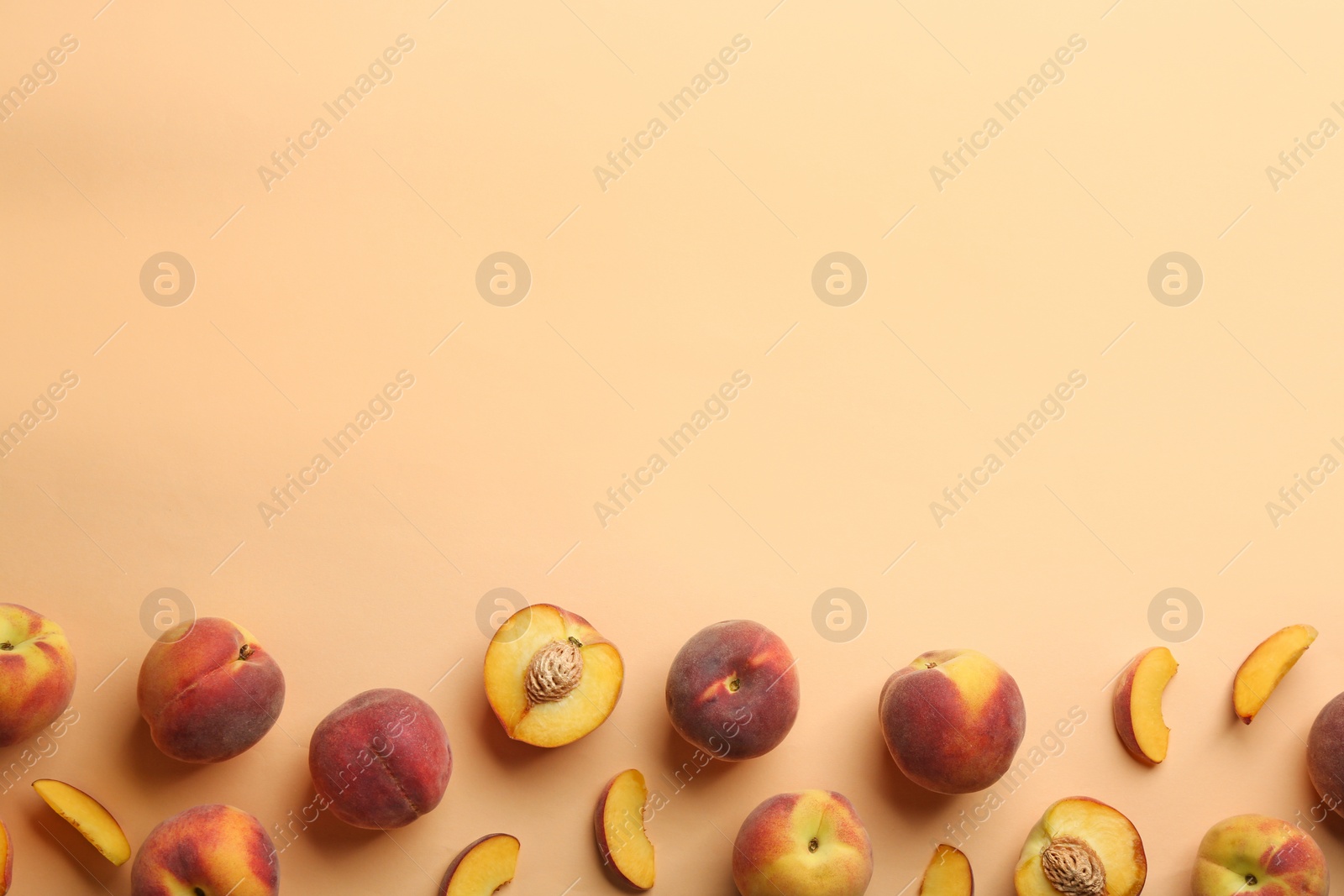 Photo of Flat lay composition with fresh peaches on beige background. Space for text