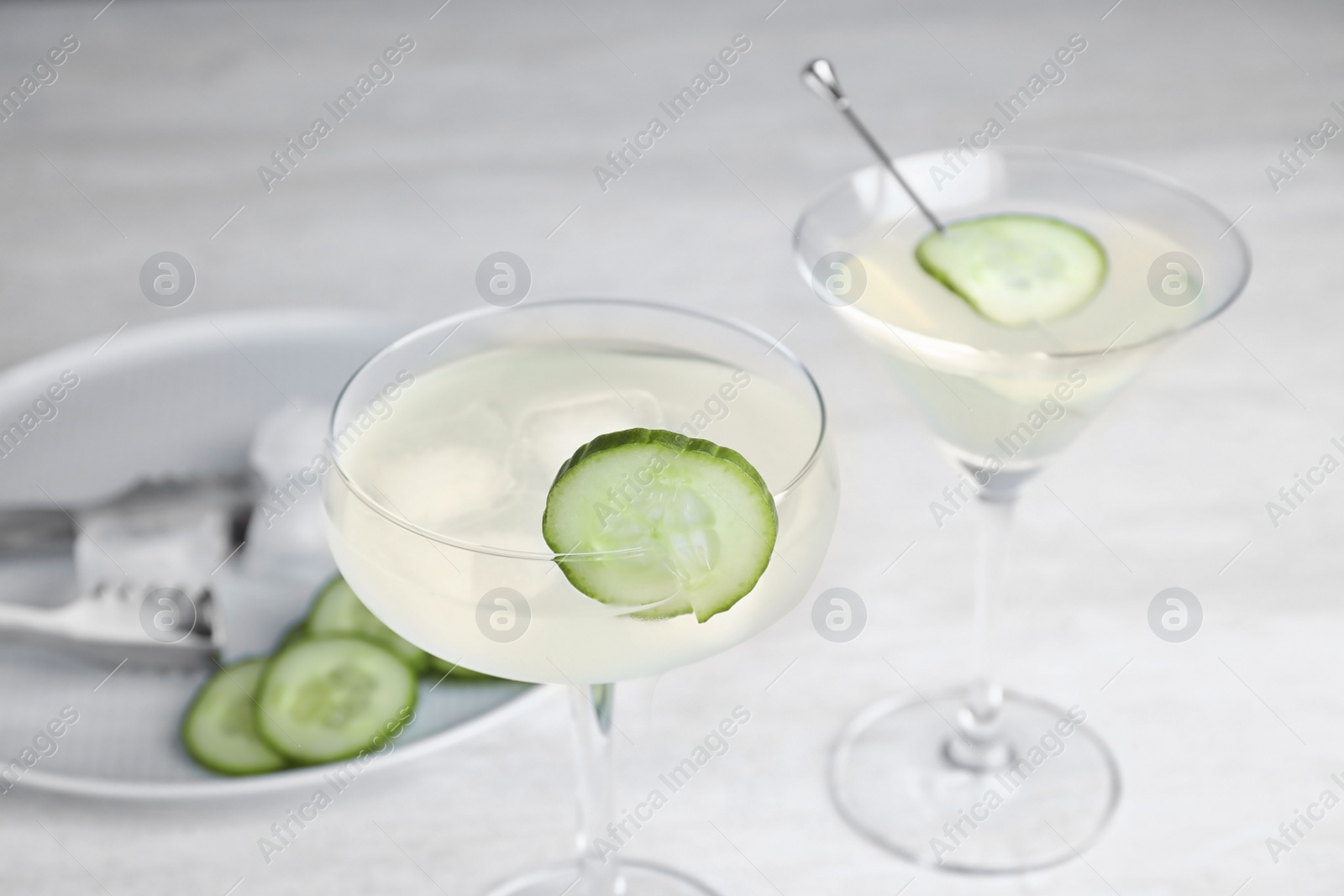 Photo of Glasses of tasty cucumber martini on grey table