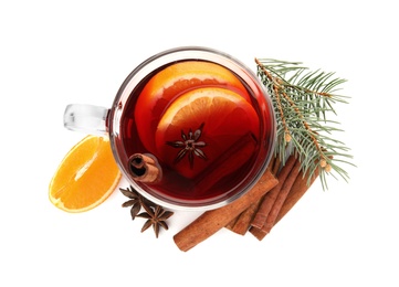 Photo of Glass cup of mulled wine, cinnamon, orange and fir branch on white background, top view