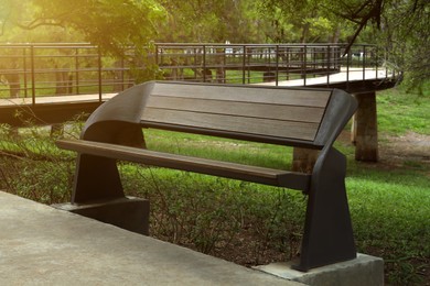 Photo of Stylish bench near trees in green park