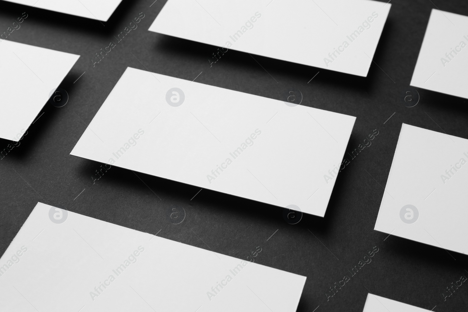 Photo of Blank business cards on black background, closeup. Mockup for design