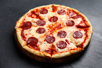 Photo of Hot delicious pepperoni pizza on dark table