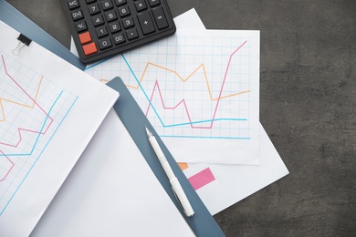 Photo of Folders with documents and calculator on office table, top view