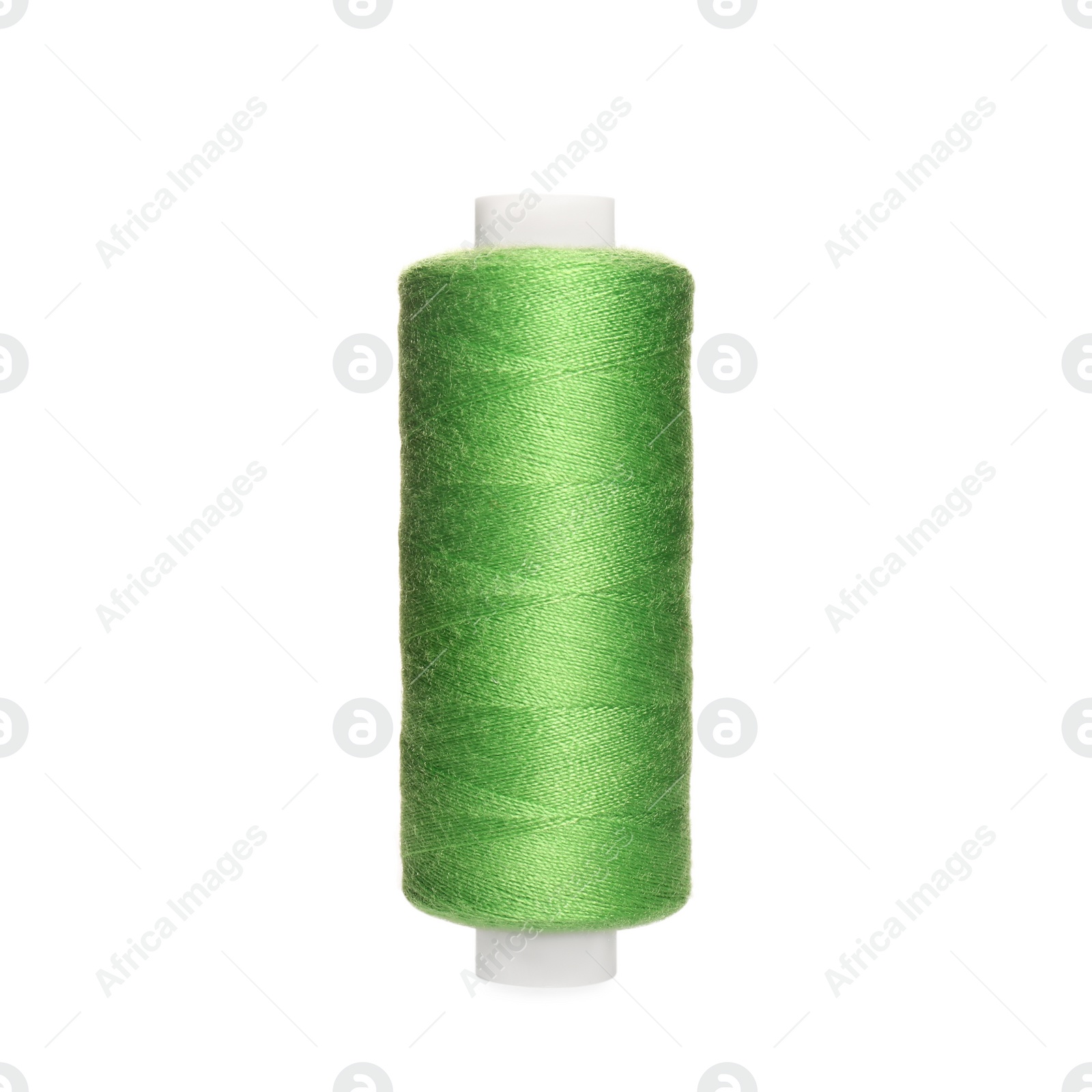 Photo of Spool of light green sewing thread isolated on white