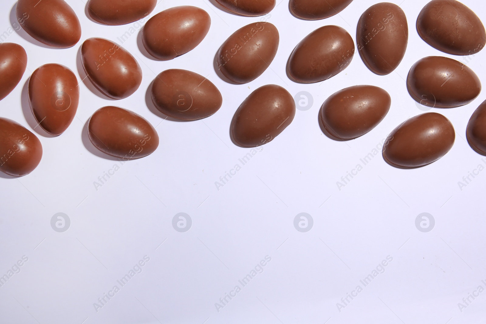 Photo of Sveti Vlas, Bulgaria - June 30, , 2023: Halves of Kinder Surprise Eggs on white background, flat lay. Space for text