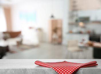 Image of Red towel on marble table in kitchen. Space for text