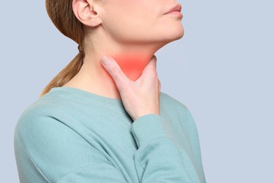 Image of Endocrine system. Woman doing thyroid self examination on grey background, closeup