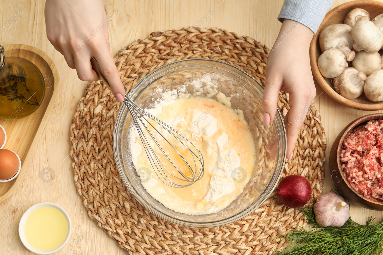 Photo of Woman making dough at wooden table, closeup