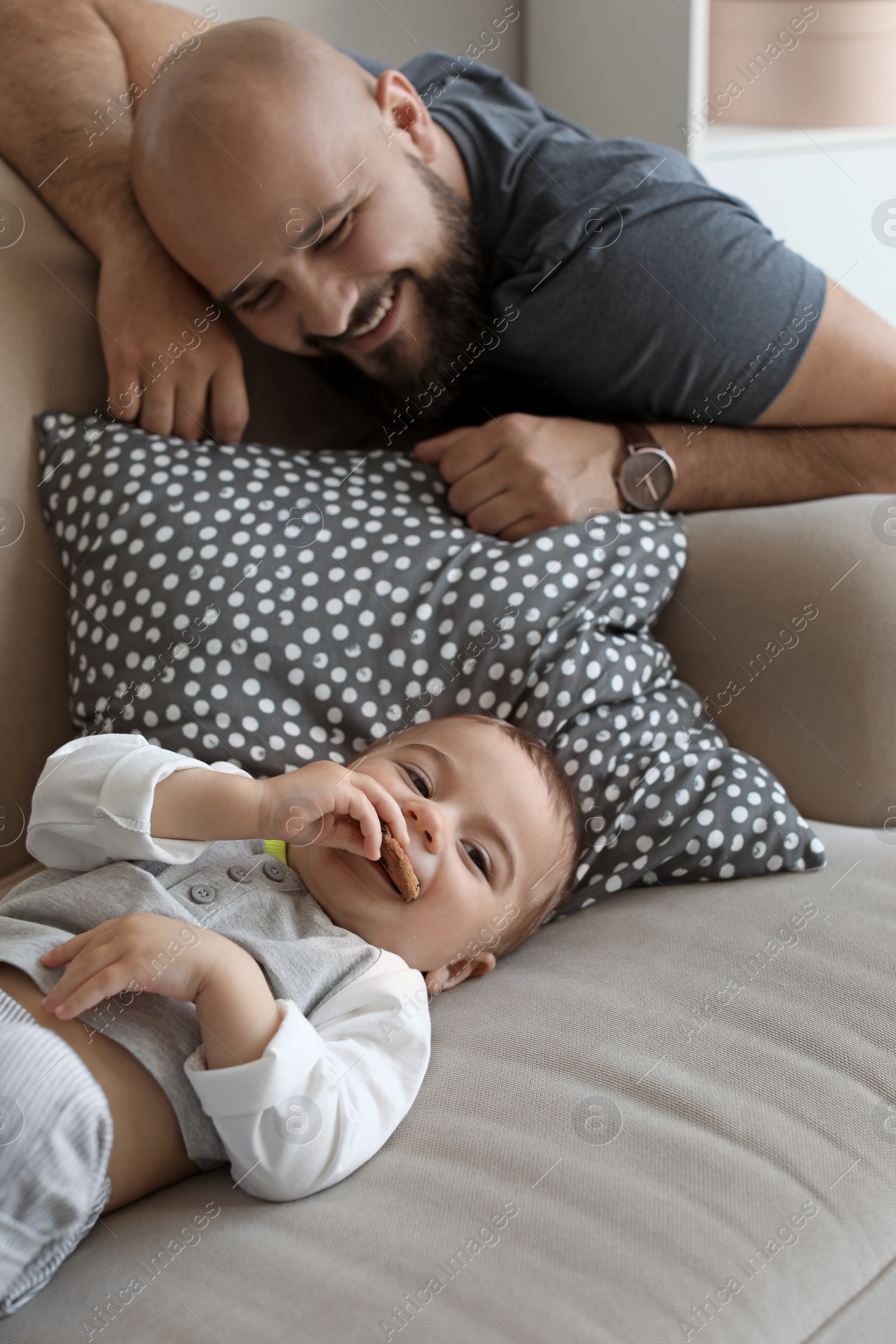 Photo of Dad and his little son spending time together at home