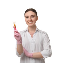 Cosmetologist with silicone cosmetic brush on white background