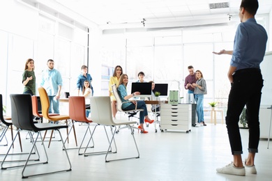 Photo of Male business trainer giving lecture in office