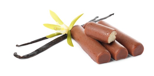 Photo of Glazed curd cheese bars, vanilla pods and flower isolated on white