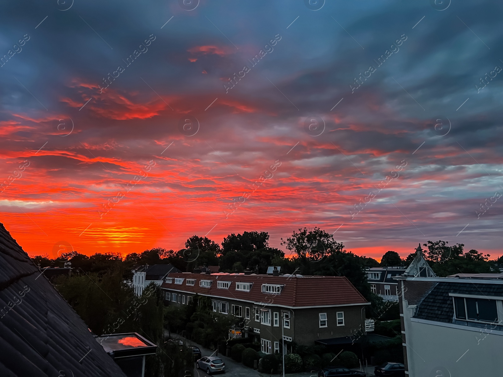 Photo of Picturesque view of city street with beautiful buildings at sunrise