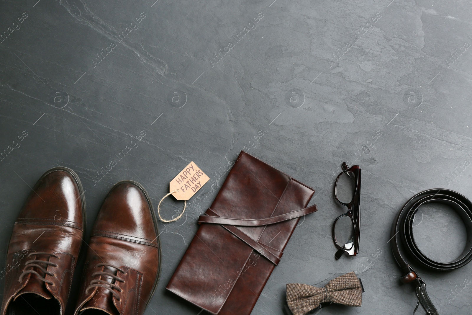 Photo of Flat lay composition with male accessories on stone background, space for text. Happy Father's Day