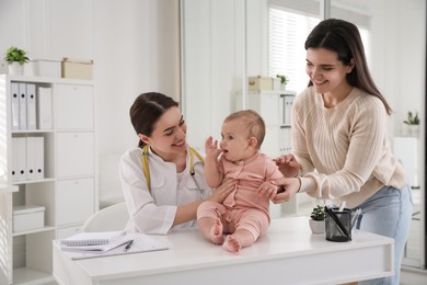 Mother with her cute baby visiting pediatrician in clinic