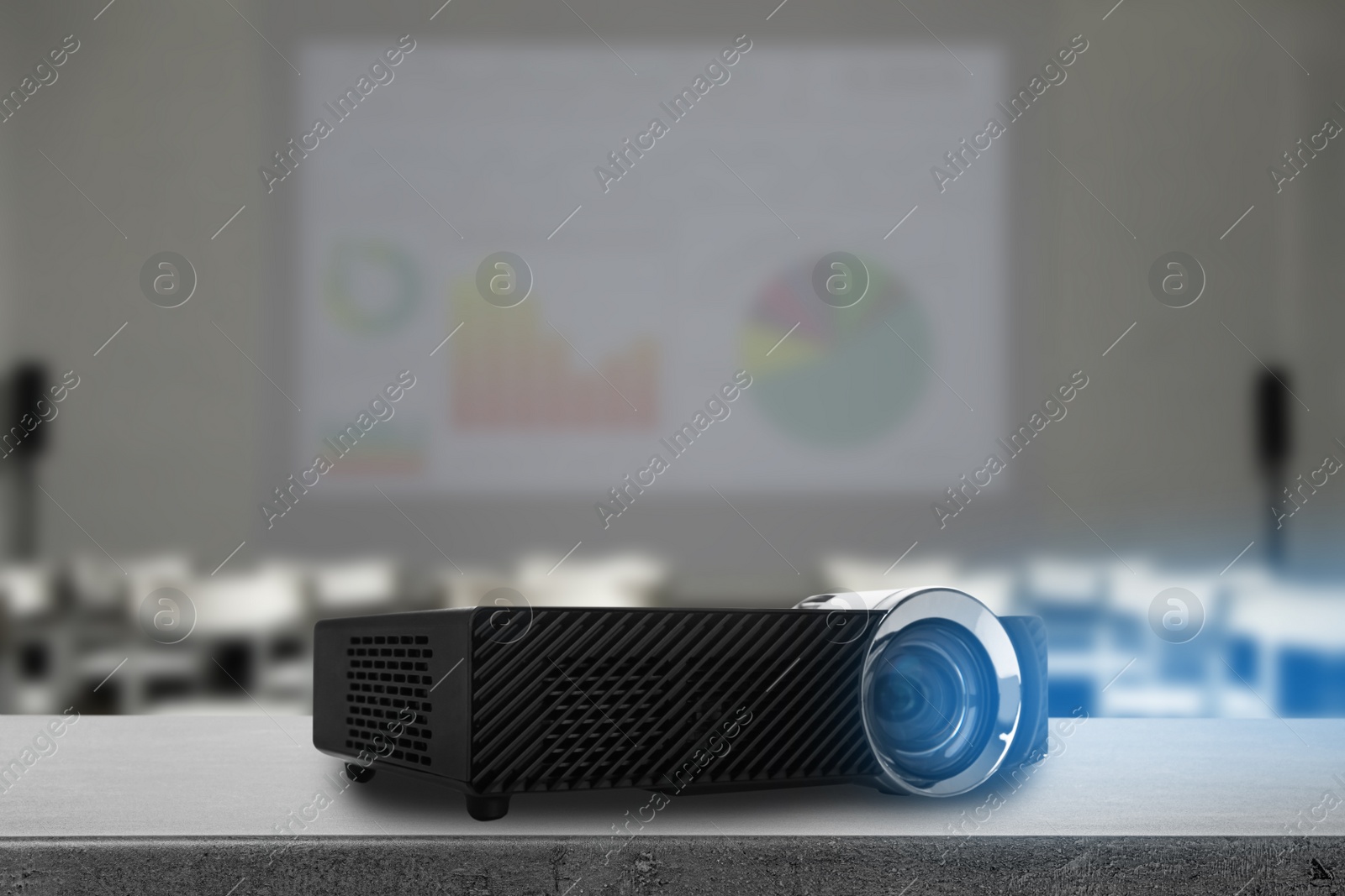 Image of Modern video projector and blurred conference room on background