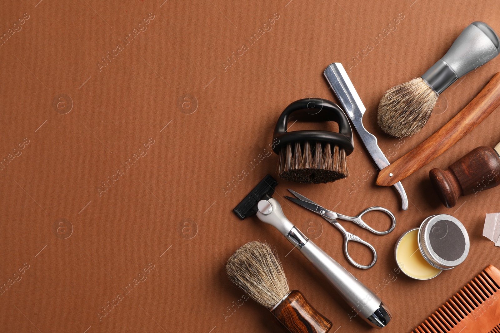 Photo of Moustache and beard styling tools on brown background, flat lay. Space for text