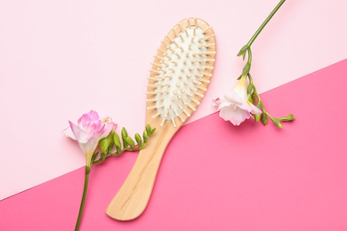Photo of Flat lay composition with wooden hair brush on color background