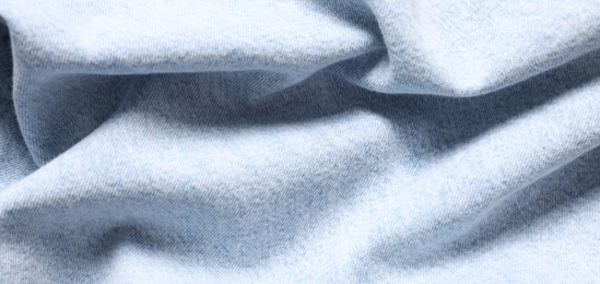 Photo of Texture of light blue crumpled fabric as background, top view