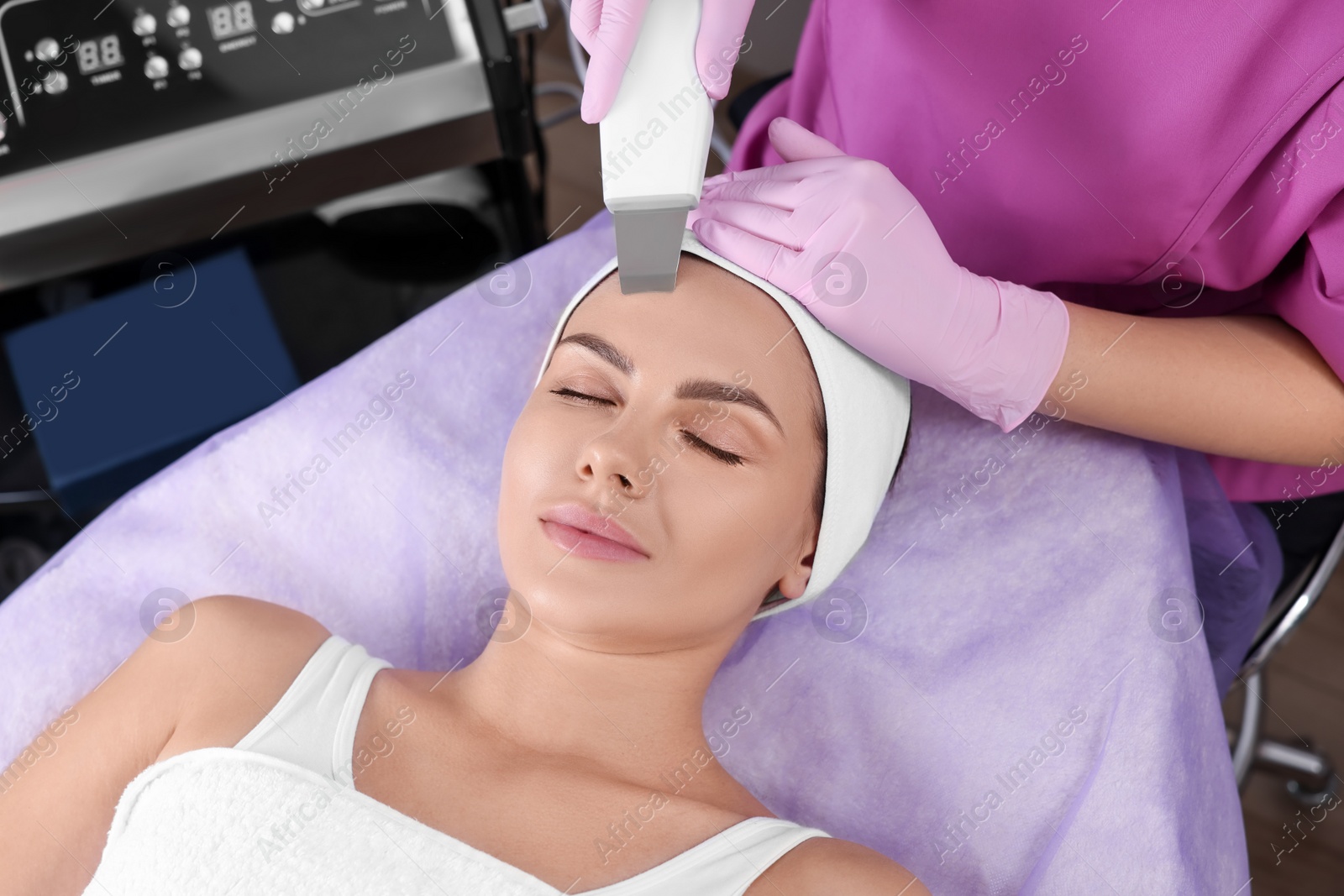 Photo of Young woman undergoing cosmetic procedure in beauty salon. Microcurrent therapy