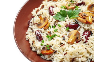 Photo of Delicious rice pilaf with mushrooms and beans isolated on white, closeup