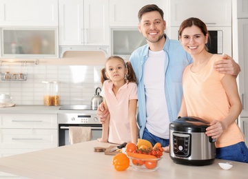 Happy family with modern multi cooker in kitchen