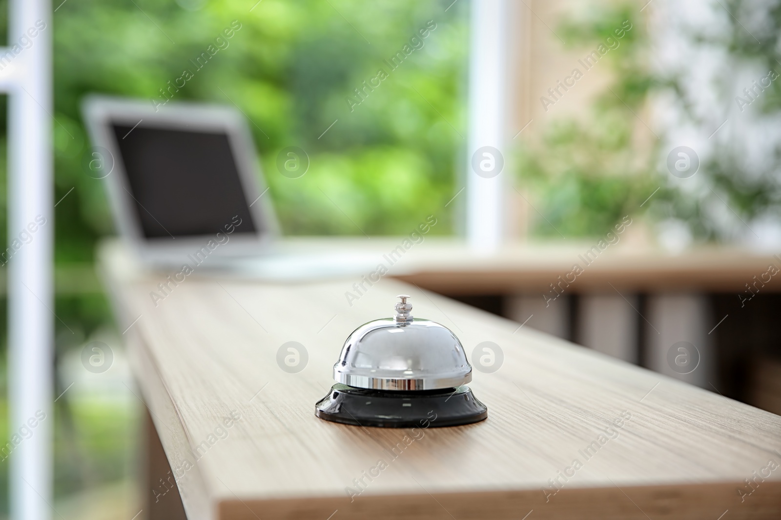 Photo of Service bell on reception desk in hotel, closeup