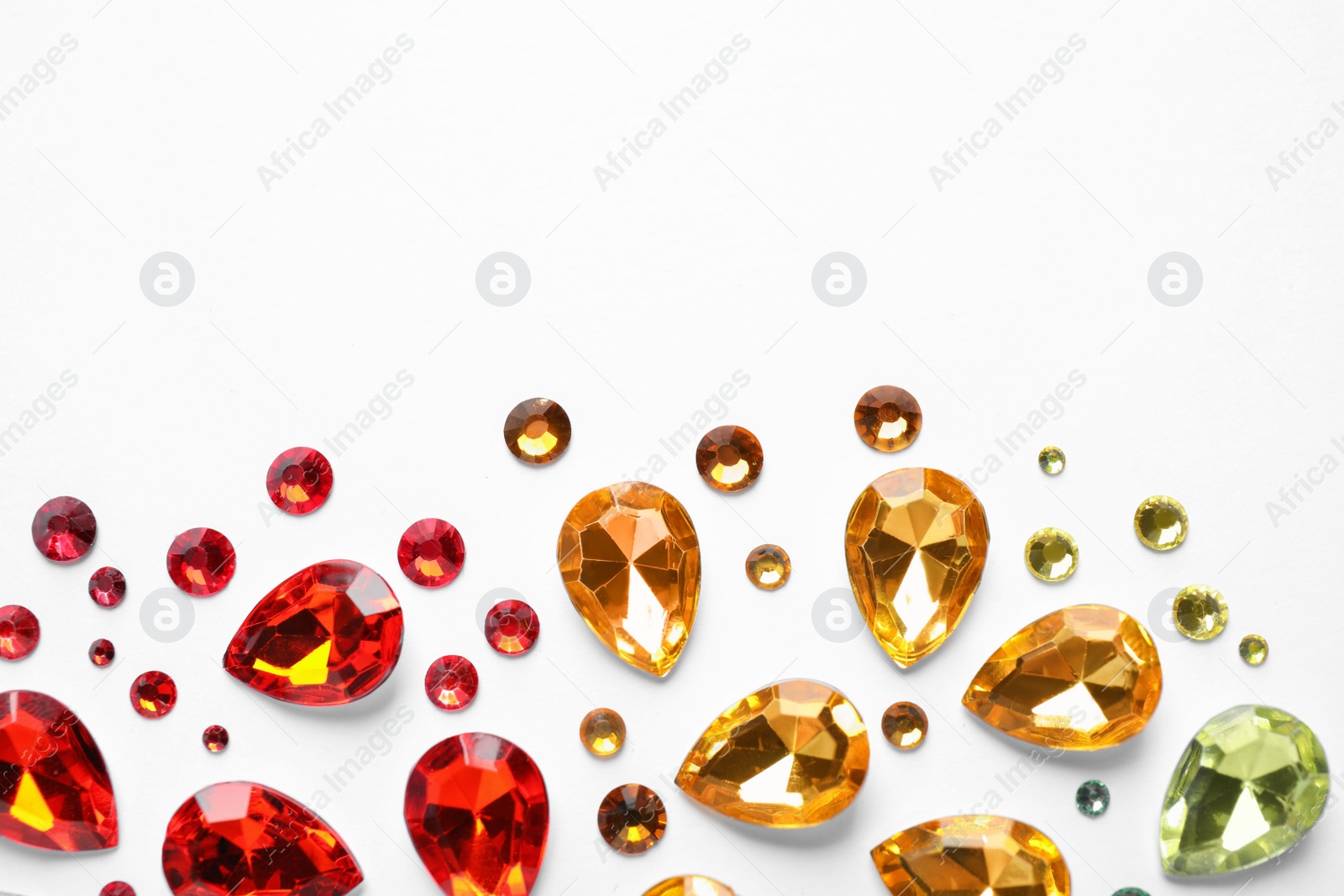 Photo of Different beautiful gemstones on white background, top view