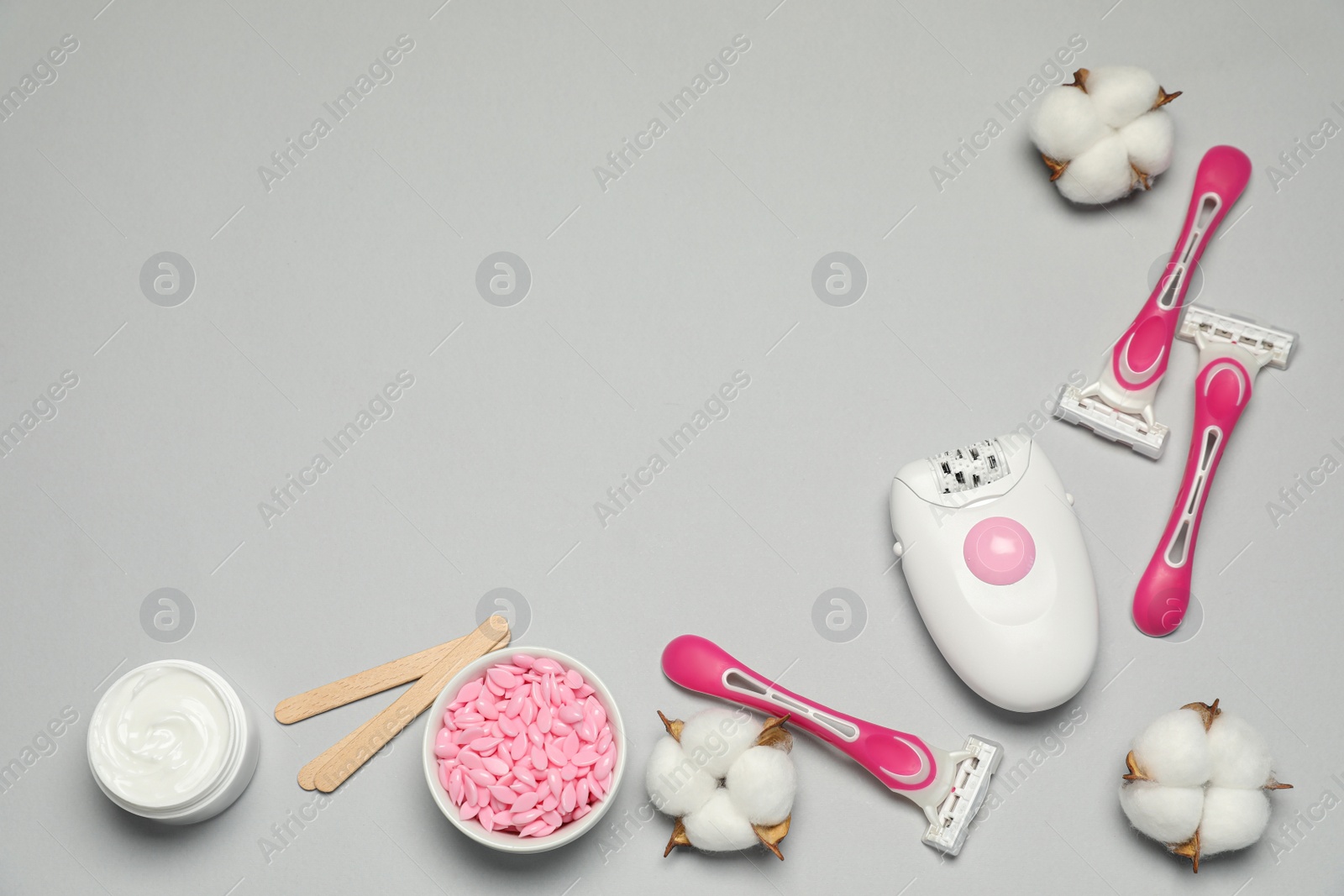 Photo of Flat lay composition with different epilation products on light grey background. Space for text