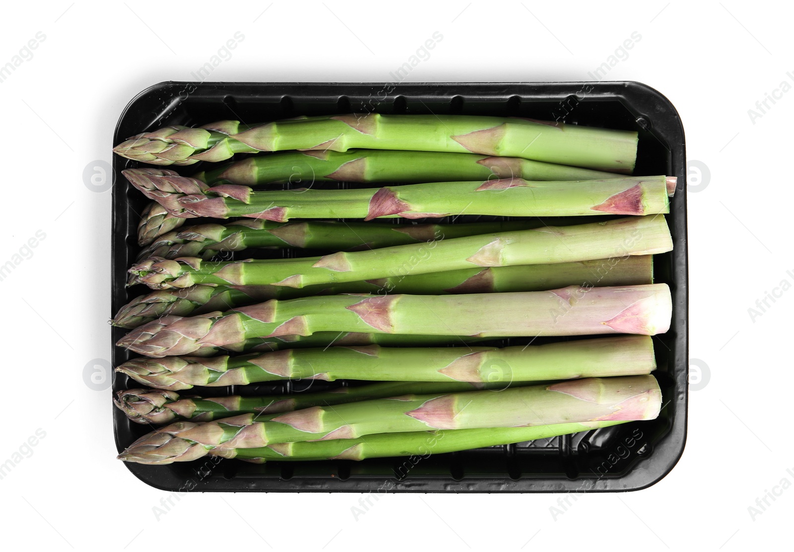 Photo of Fresh raw asparagus in plastic container isolated on white, top view